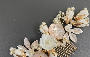 Detail of bridal hair comb with ceramic flowers, gold leaves and white faux pearls