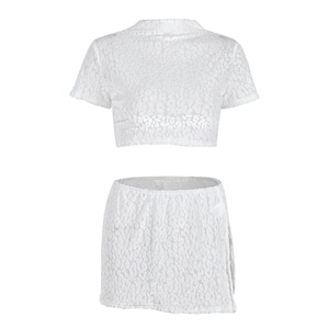 Detail of white two-piece set featuring leopard flocking texture and side slit mini skirt