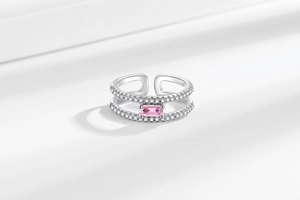 Detail of silver double-layer ring with pink rectangular gem and micro-set cubic zirconia