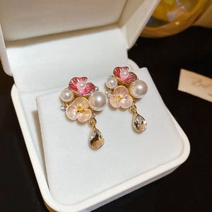Pink enamel flower and pearl drop earrings with crystal charms in a jewelry box