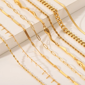 Collection of gold stainless steel necklaces including Cuban, snake, and cable chain styles