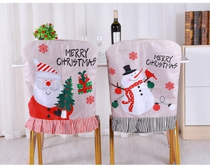 Detail of Christmas chair covers featuring Santa and Snowman with striped ruffle trim