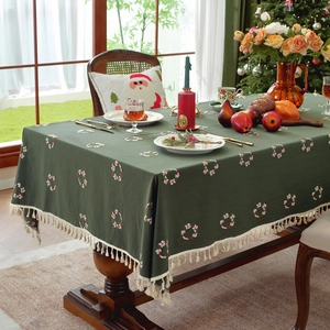 Green cotton Christmas tablecloth with embroidered wreaths and beige tassel edges