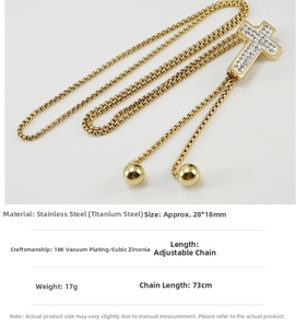 Detail of 18K gold plated stainless steel cross pendant with inlaid white rhinestones