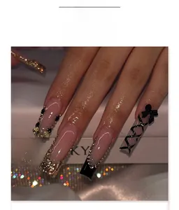 Close-up of gothic French long square nails with black pink bows and sparkling rhinestones