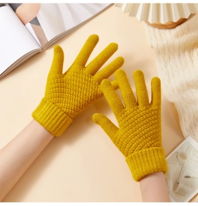 Close-up of yellow knit winter gloves with diamond texture and ribbed cuffs for warmth