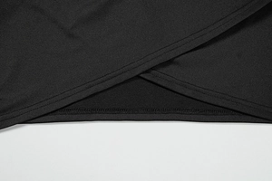 Close-up detail of black knitted dress fabric with cross wrap design and double stitching