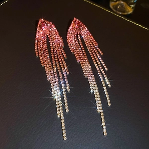 Detailed view of silver needle tassel earrings with pink gradient rhinestones and luxury finish