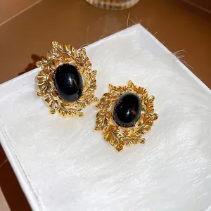 Vintage oval black stone stud earrings with gold filigree leaf frame for women