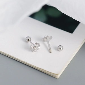 Macro shot of silver flower stud earring with screw back on a white background