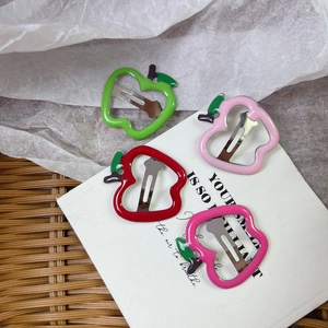 Detailed view of hollow apple hair clips in four pastel colors with metal duckbill clips