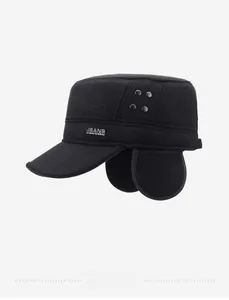 Detail of warm winter military cap with ear flaps and decorative metal buttons