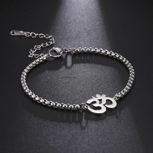 Silver Om yoga symbol anklet with box chain and adjustable lobster clasp on dark background
