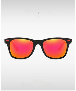 Detail of matte black sunglasses with red gradient lenses and capsule temple accent