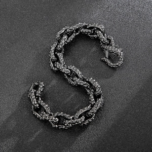 Macro view of gunmetal chain bracelet with vintage hammered texture and hook clasp