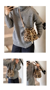 Detail of leopard print bucket bag with golden chain drawstring and pearl pendant charms