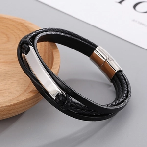 Detail of multi-layer braided black leather bracelet with silver magnetic steel clasp