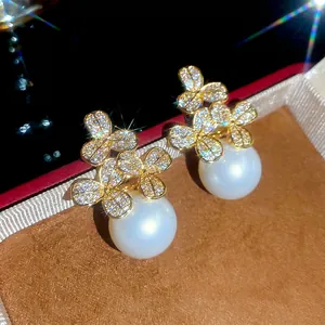 Elegant gold flower earrings with zircon pavé petals and large white round pearls