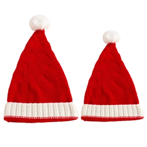Matching red cable knit Christmas hats for mother and baby with white pom-poms