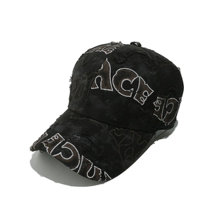 Detailed close-up of distressed black cotton baseball cap with embroidered PACE lettering