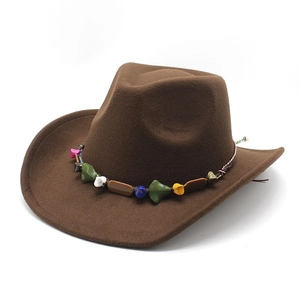 Detail of brown felt cowboy hat featuring ethnic colorful beaded band on a white background
