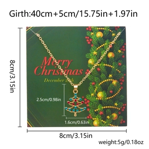 Detailed view of golden Christmas tree pendant necklace on green display card with size specs