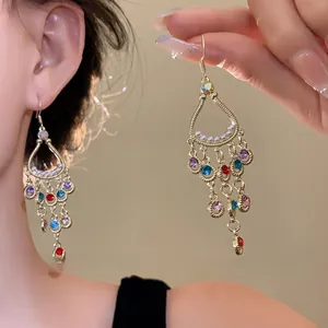 Detail shot of vintage floral shell tassel earrings with colorful gems and gold hooks