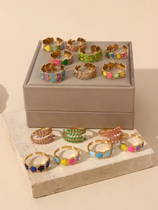 Detail of colorful enamel star and leaf adjustable 18k gold plated open rings