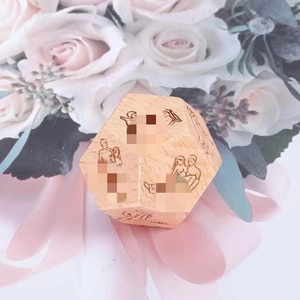 Detailed close-up of a 12-sided wooden date night dice with engraved activity icons