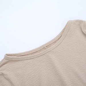 Detail view of the round neckline and textured fabric stitching on this evening dress