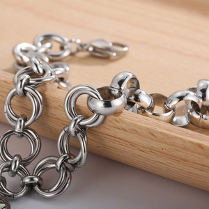 Fashionable stainless steel chunky chain heart bracelet with lobster clasp on wood tray