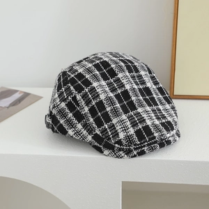 Close-up detail of British style houndstooth wool fabric on children's beret hat