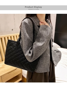 Classic black quilted faux leather tote bag showcased in a lifestyle indoor setting