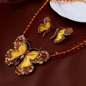 Vintage butterfly necklace and earrings set with amber glass beads and yellow rhinestones
