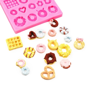 Pink silicone mold for mini donuts and waffles with colorful finished clay samples
