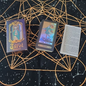 Detailed view of holographic 78-card Tarot set with The Fool card and English manual