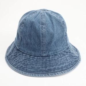 Detail of blue denim bucket hat showing white stitching lines and washed fabric texture