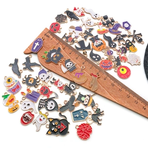 Mix of colorful Halloween enamel charms with a ruler showing the 1-3cm size scale