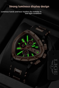Macro shot of luminous green watch hands and triangle dial markers in the dark