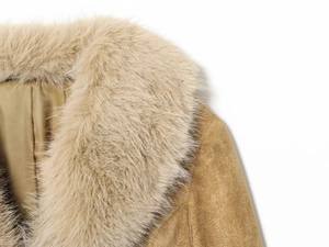 Detail shot of plush faux fur collar and premium camel suede texture on the women's blazer