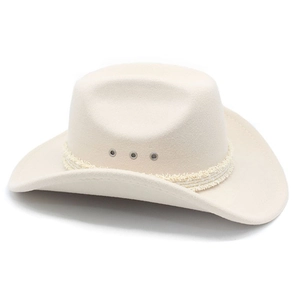 Close-up of cream wool cowboy hat featuring a metallic M logo and fringe band detail