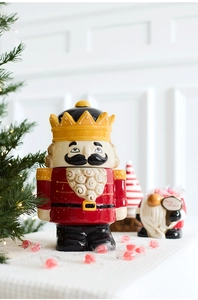 Close-up of a festive nutcracker ceramic candy jar with vibrant red soldier uniform