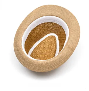 Internal view of a handwoven straw fedora showing the white sweatband and texture
