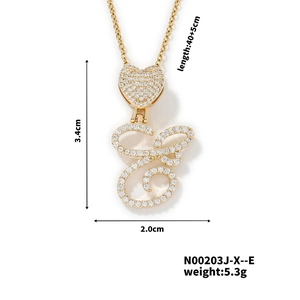 Detail showing gold heart pendant with letter S and E encrusted with white zircon stones