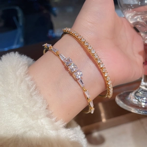 Detailed view of 18K gold plated bangle with square zircon settings and vintage sparkle