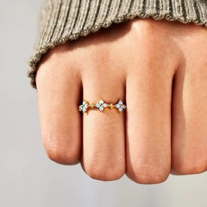Minimalist S925 silver ring with three light blue flowers on model finger