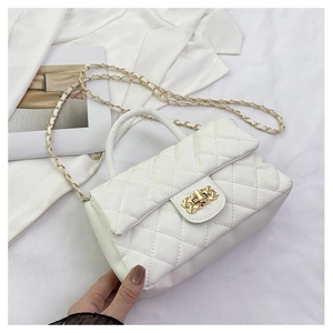 Detailed top view of a white quilted handbag with golden chain and twist lock mechanism