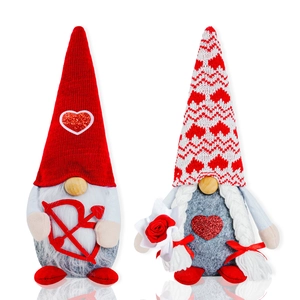 Detail of Valentine's Day gnome plush pair with heart bow and knitted heart hat