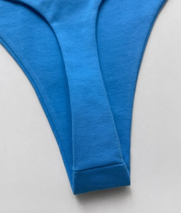 Macro shot of cobalt blue cotton thong showing seamless stitching and soft knit fabric