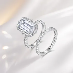 Detailed close-up of emerald-cut moissanite silver rings set with pavé accents